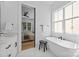 Bright bathroom showcasing a freestanding tub by a large window and a glimpse into an adjacent bedroom at 3949 Plainview Rd, Charlotte, NC 28208