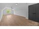Spacious bedroom featuring hardwood floors, a ceiling fan, and a window with natural light at 3949 Plainview Rd, Charlotte, NC 28208