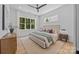 Serene bedroom with a large window offering a nature view, hardwood floors, and soft, neutral tones at 3949 Plainview Rd, Charlotte, NC 28208