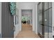 Warm entryway with stylish lighting and view into the living room through glass doors at 3949 Plainview Rd, Charlotte, NC 28208