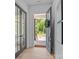 Welcoming entryway with hardwood floors, glass-paneled doors, and a view of the front porch at 3949 Plainview Rd, Charlotte, NC 28208
