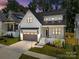 Striking two-story home with a white exterior, grey garage door, and professional landscaping at 3949 Plainview Rd, Charlotte, NC 28208