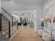 Inviting foyer with hardwood floors, staircase with iron railing, and a view of the open-concept living area at 3949 Plainview Rd, Charlotte, NC 28208