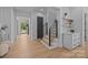 Bright hallway featuring hardwood floors, modern staircase, and stylish built-in cabinets with marble countertop at 3949 Plainview Rd, Charlotte, NC 28208