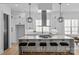 A spacious kitchen boasts a large central island with seating and stylish pendant lighting at 3949 Plainview Rd, Charlotte, NC 28208