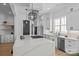 Modern kitchen featuring white cabinets, stainless steel appliances, a large center island, and pendant lighting at 3949 Plainview Rd, Charlotte, NC 28208