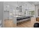 Open-concept kitchen with a large island, seating, modern appliances, and plenty of natural light at 3949 Plainview Rd, Charlotte, NC 28208