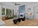 Inviting living room with hardwood floors, designer furniture, fireplace, and large windows at 3949 Plainview Rd, Charlotte, NC 28208
