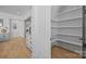 Bright pantry offers ample storage with custom shelving solutions and convenient access to kitchen and dining at 3949 Plainview Rd, Charlotte, NC 28208