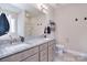 Double vanity bathroom with granite counters, sleek fixtures, and tiled floors at 4017 Avis Way, Monroe, NC 28110