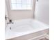 Bright bathtub with sleek fixtures, and tiled floors at 4017 Avis Way, Monroe, NC 28110