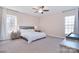 Neutral Primary bedroom with large windows, carpeted floor, ceiling fan, and ensuite bathroom at 4017 Avis Way, Monroe, NC 28110
