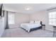 Neutral Primary bedroom with large windows, carpeted floor, and ensuite bathroom at 4017 Avis Way, Monroe, NC 28110