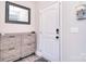 Welcoming entryway with modern storage cabinet and light neutral walls at 4017 Avis Way, Monroe, NC 28110