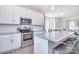 Modern kitchen with white cabinets, stainless steel appliances, and a large island at 4017 Avis Way, Monroe, NC 28110