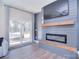 Living room with modern fireplace and easy access to the outdoor patio at 4017 Avis Way, Monroe, NC 28110