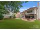 Large backyard featuring lush lawn, outdoor kitchen, and entertainment space at 4023 Alexandra Alley Dr, Charlotte, NC 28210