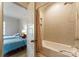 Clean bath/shower combo adjoins bedroom with two twin beds, offering comfort and convenience at 4023 Alexandra Alley Dr, Charlotte, NC 28210