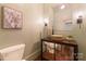 Stylish powder room with unique vanity, elegant fixtures, and decorative mirror at 4023 Alexandra Alley Dr, Charlotte, NC 28210