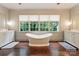 Bright bathroom featuring a freestanding tub under a window with views, and and vanities at 4023 Alexandra Alley Dr, Charlotte, NC 28210