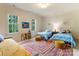 Bright bedroom features two twin beds, colorful rug, and natural light at 4023 Alexandra Alley Dr, Charlotte, NC 28210