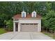 Detached garage with painted brick, complementary trim, arched dormers, and smooth concrete drive at 4023 Alexandra Alley Dr, Charlotte, NC 28210