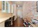 Hallway with a brick wall, built-in shelves, a desk and hardwood floors at 4023 Alexandra Alley Dr, Charlotte, NC 28210
