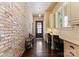 Hallway with a brick wall, built-in shelves, a desk and hardwood floors at 4023 Alexandra Alley Dr, Charlotte, NC 28210