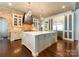 Bright and airy kitchen featuring exposed brick, custom cabinetry and a large center island at 4023 Alexandra Alley Dr, Charlotte, NC 28210