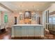 Gourmet kitchen features a large island, stainless steel appliances, and brick accent wall at 4023 Alexandra Alley Dr, Charlotte, NC 28210