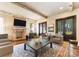 Comfortable living room featuring a brick fireplace, wood floors, and exposed beams at 4023 Alexandra Alley Dr, Charlotte, NC 28210