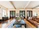 Spacious living room featuring exposed beams, wood floors, and comfortable furniture at 4023 Alexandra Alley Dr, Charlotte, NC 28210