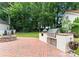 Outdoor kitchen features a built-in grill and brick patio, perfect for entertaining at 4023 Alexandra Alley Dr, Charlotte, NC 28210