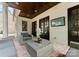 Covered patio features comfortable seating, an outdoor TV, and elegant brickwork at 4023 Alexandra Alley Dr, Charlotte, NC 28210