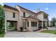 Rear exterior showcasing covered parking, multiple access points, a brick patio, and manicured landscaping at 4023 Alexandra Alley Dr, Charlotte, NC 28210