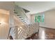 Well-lit staircase with dark wood floors and white decorative railings offers safety and beauty at 4023 Alexandra Alley Dr, Charlotte, NC 28210