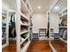 Spacious walk-in closet featuring custom shelving and full-length mirrors on either side at 4023 Alexandra Alley Dr, Charlotte, NC 28210