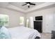Comfortable bedroom boasts a ceiling fan, a dresser, and a large window with natural light at 411 Lahinch Dr, Tega Cay, SC 29708