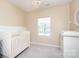 Well-lit Bedroom features a white crib, a changing table, and a charming chandelier at 411 Lahinch Dr, Tega Cay, SC 29708