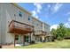 Charming townhouse featuring private wooden decks, sliding glass doors, and a well-maintained backyard with lush green grass at 411 Lahinch Dr, Tega Cay, SC 29708