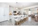 Open kitchen features white cabinets, a large island with seating, stainless steel appliances and easy access to the living room at 411 Lahinch Dr, Tega Cay, SC 29708