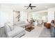 Open-concept living room features hardwood floors, neutral decor, a sectional sofa, and easy access to the kitchen at 411 Lahinch Dr, Tega Cay, SC 29708