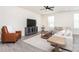 Inviting living room featuring hardwood floors, neutral walls, a sectional sofa, and a mounted TV at 411 Lahinch Dr, Tega Cay, SC 29708