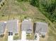 Aerial view of a house with a spacious backyard featuring a fire pit, bordered by a black fence and green grass at 4268 Coachwhip Ave, Lancaster, SC 29720