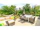 Outdoor patio with dining and lounge areas, featuring a hammock and lush landscaping, ideal for relaxation and entertaining at 4268 Coachwhip Ave, Lancaster, SC 29720