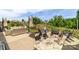 Spacious outdoor patio featuring a fire pit, comfortable seating, dining area, hammock, and lush green landscaping at 4268 Coachwhip Ave, Lancaster, SC 29720