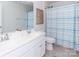 Bathroom featuring a double sink vanity and a shower with a blue and white patterned curtain at 4268 Coachwhip Ave, Lancaster, SC 29720