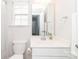 Well-lit bathroom featuring a white vanity, toilet, and a large mirror reflecting the clean and modern design at 4268 Coachwhip Ave, Lancaster, SC 29720