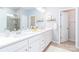 Bright bathroom with double sinks, white cabinetry, and decorative accents above the sinks at 4268 Coachwhip Ave, Lancaster, SC 29720