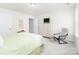 Bright bedroom with a green patterned comforter, white dresser, and a comfortable reading chair at 4268 Coachwhip Ave, Lancaster, SC 29720